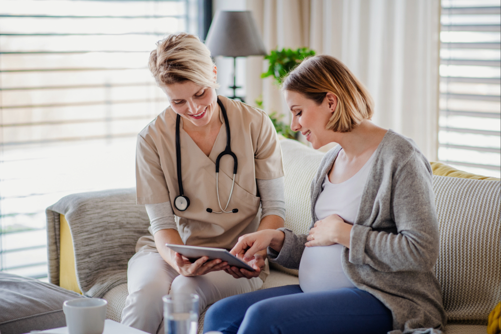 Woman speaking with a nurse.